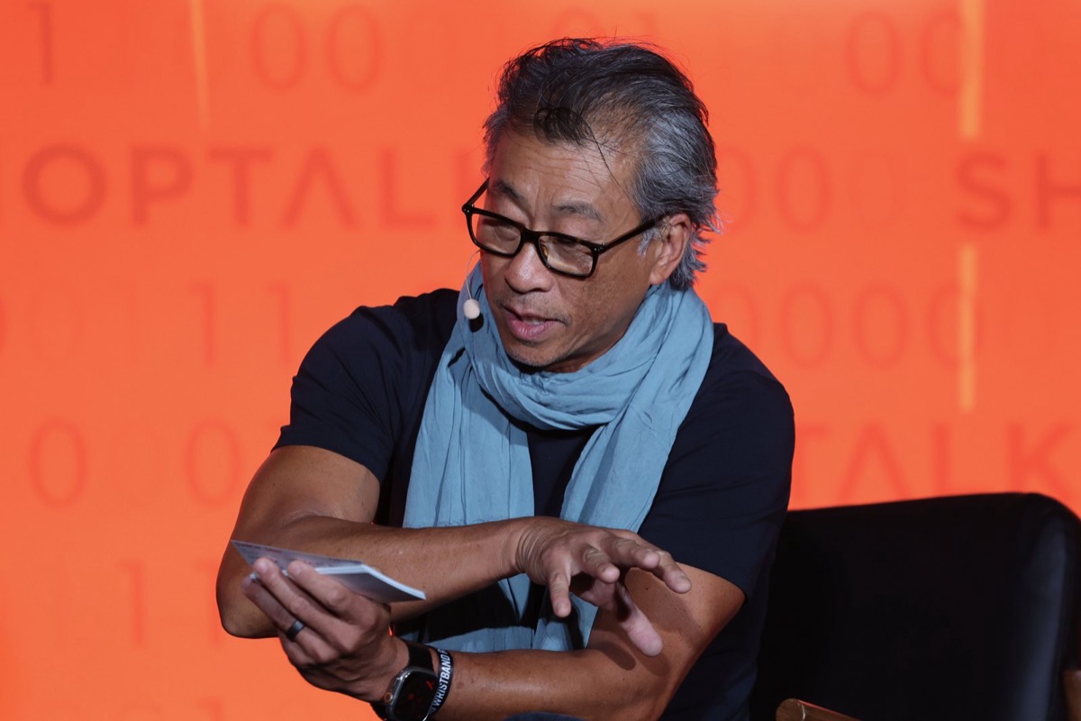 Wilson moderating a panel on stage at ShopTalk